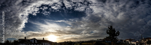 Sunset panorama with hight contrast sky with clouds