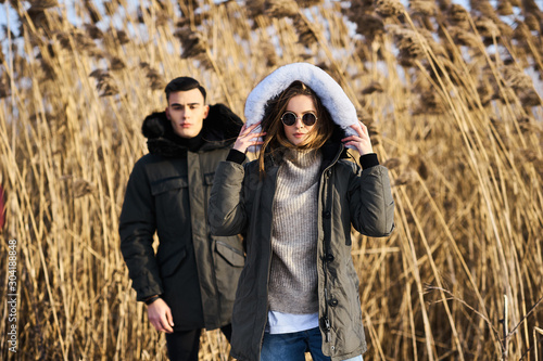 happy couple hugging and laughing outdoors in winter