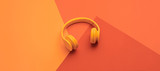 Minimal fashion, Trendy coral neon headphones. Music vibration on geometry background. Hipster DJ accessory Flat lay. Art creative summer vibes, fashionable pop art style. Bright neon color, banner