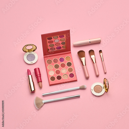 Fashion beauty product layout. Woman Essentials cosmetic makeup Set. Collection beauty accessories background. Trendy Brushes, art Design pastel Flat lay. Creative cosmetics shopping concept on pink