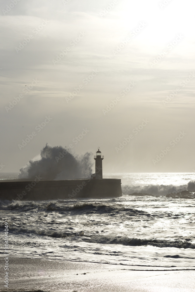 lighthouse with rough waves as background