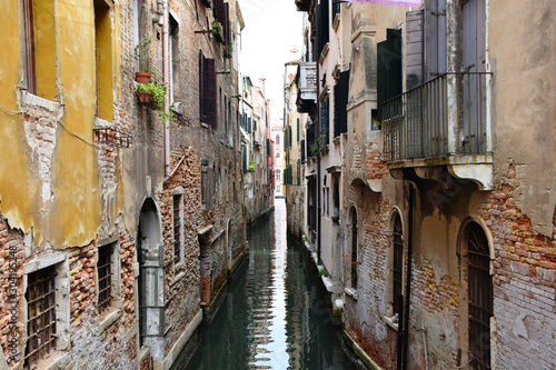 Narrow Water Canal Between Residential Houses in a Quiet Area of Venice, Italy