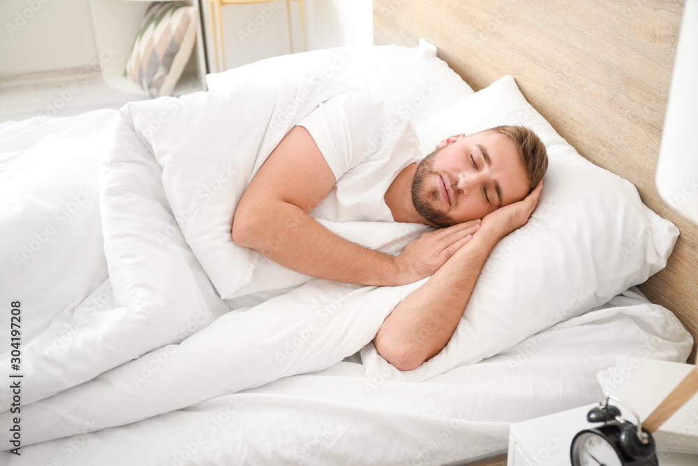 Morning of young man sleeping in bed Morning of young man sleeping in bed