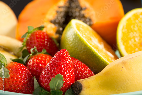 some fruit on plate with black background
