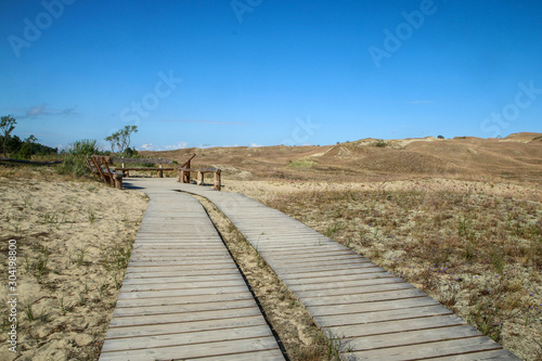 A picture from the Curonian Spit  Kursiu Nerija  National Park in Lithuania. The wooden tourist path climbing to the top of the sand dune. 