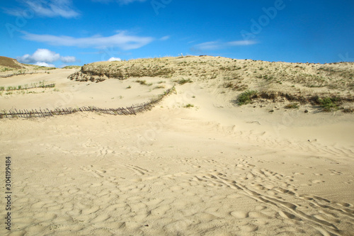 A picture from the Curonian Spit (Kursiu Nerija) National Park in Lithuania. The big sand dunes by the shore during the nice sunny day. 