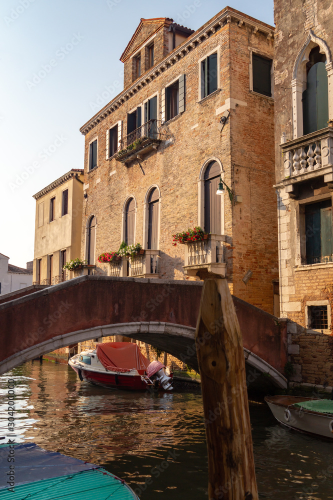 Venice, Italy. Boats and low bridge on a channel