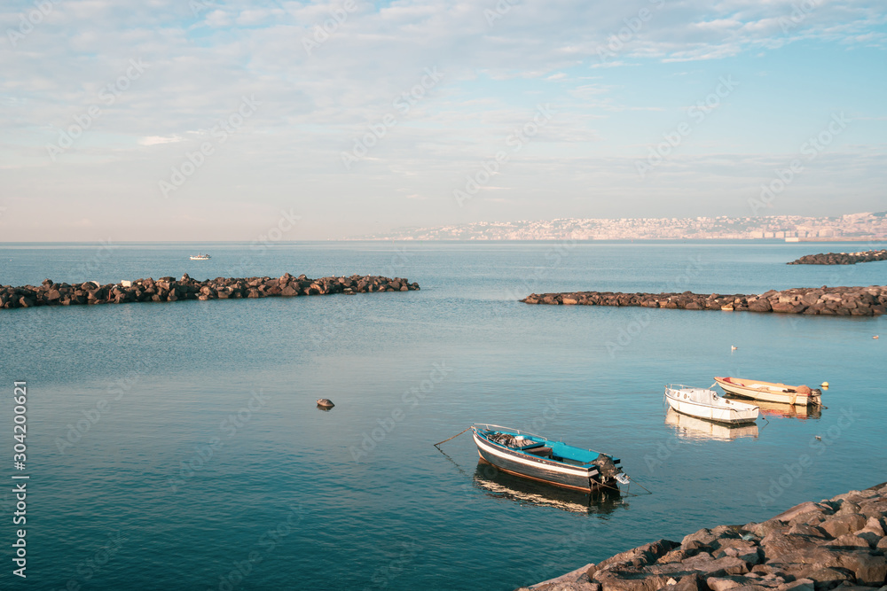 Obraz premium Fishing boats floating on the Mediterranean sea shore. Italy.