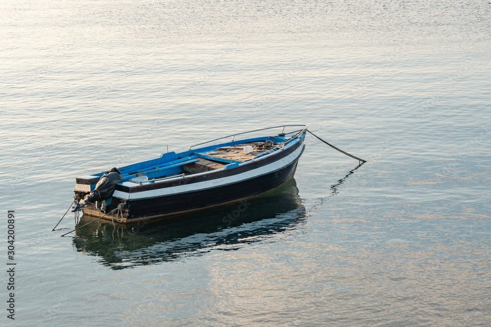 Naklejka premium Fishing boat floating on the Mediterranean sea shore. Italy.