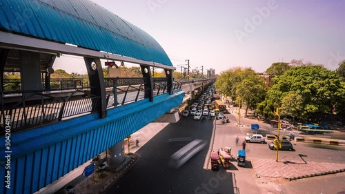 Elevated metro station above a busy road intersection in New Delhi downtown time lapse
