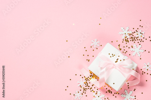 Christmas flat lay background with christmas present box on pink. © nadianb