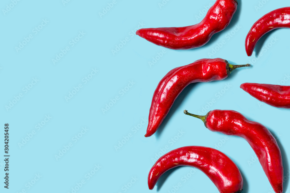 Top view of fresh chilli pepper isolated on blue background. Minimal food concept. Flat lay Top view of fresh chilli pepper isolated on blue background. Minimal food concept. Flat lay