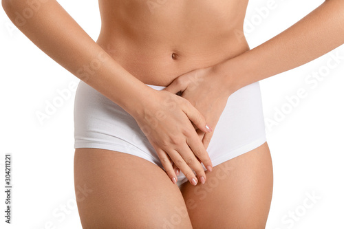 Young woman suffering from abdominal pain on white background. Gynecology concept © Pixel-Shot