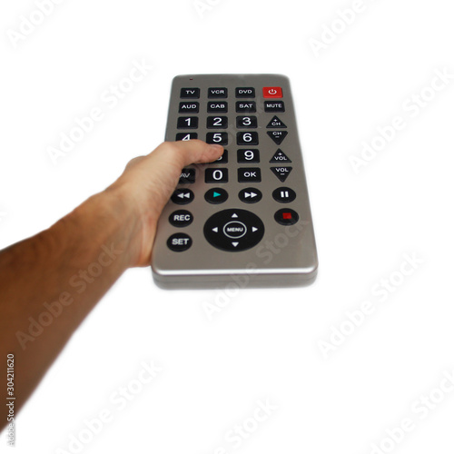 man hand holding tv conssole. Isolated on white background. thumb presses the button