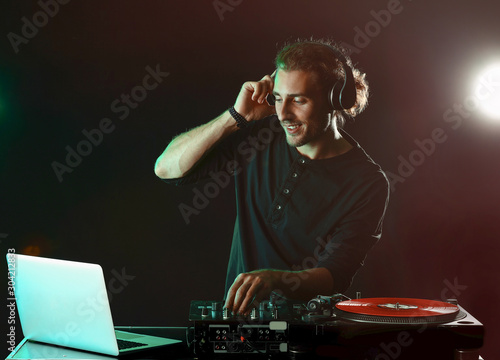 Male dj playing music in nightclub