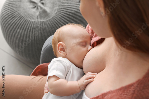 Young woman breastfeeding h...