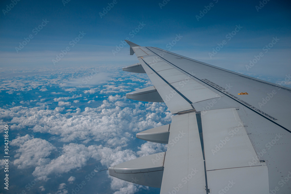 airplane wing over clouds airplane wing over clouds