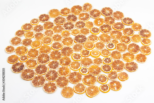 large number of dried lemon slices on a white background. vitamin fruit food