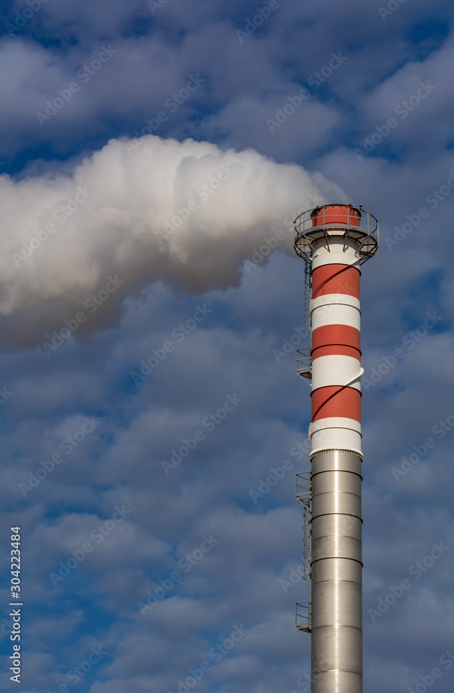 Obraz premium Red and White Chimney Smoking on Cloudy Sky Background