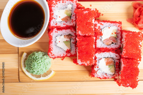 California roll with red flying fish caviar, with wassabi and ginger. photo