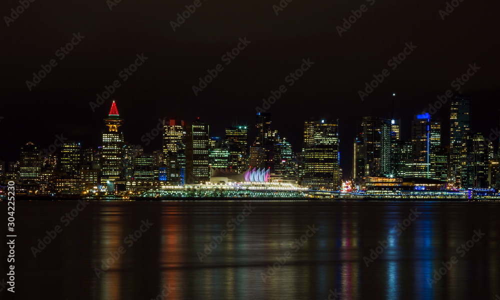 The downtown Vancouver skyline at night from North Vancouver. Canada Place and Tower Illuminated with Christmas stile