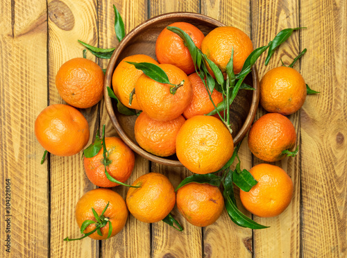 tangerine mandarin fruits scattered on old wooden background