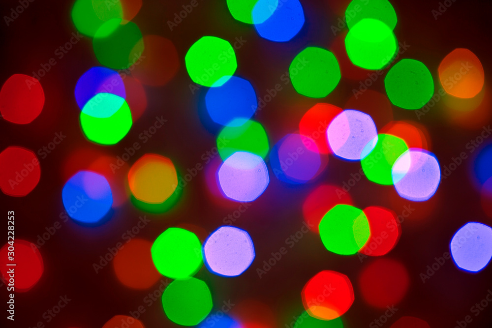 Multicolored defocused blurry lights, Christmas garlands lights, festive background.