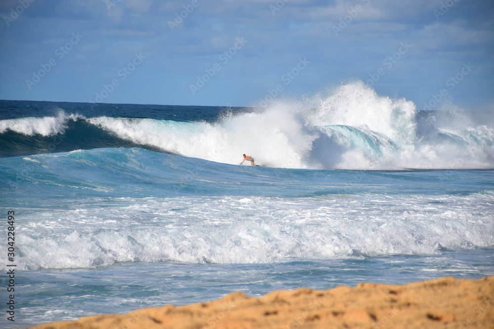 9/10: Hawaiian Surfer Taking on a Massive Rainbow Wave at the Banzai Pipeline, Oahu, Hawaii