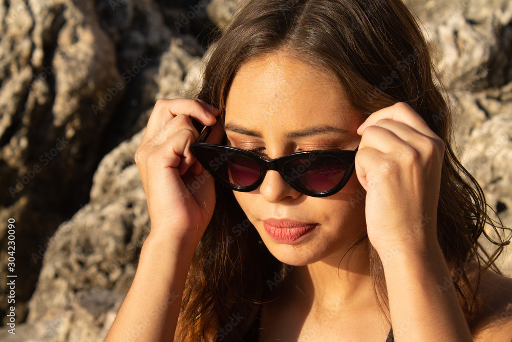 Portrait of young hipster woman with sunglasses enjoying summer. Autumn is approaching with good temperatures. Summer in South America Portrait of young hipster woman with sunglasses enjoying summer. Autumn is approaching with good temperatures. Summer in South America