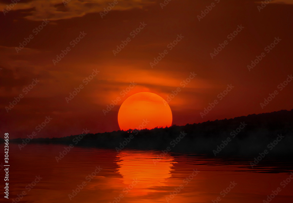 sunrise on the seashore, the yellow sun with reflection on the water
