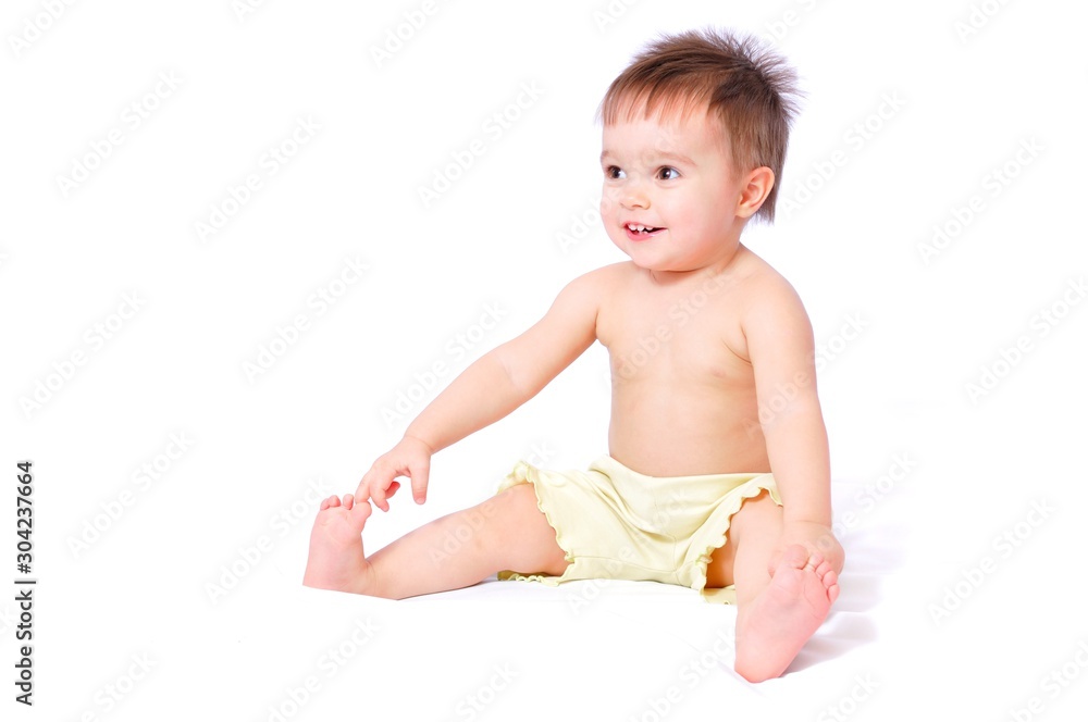 Sitting baby in shorts holding toe Sitting baby in shorts holding toe