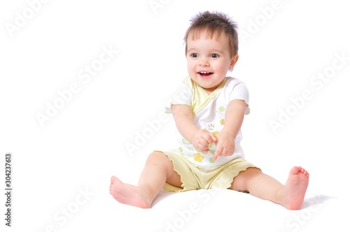 Sitting baby girl in child wear fun