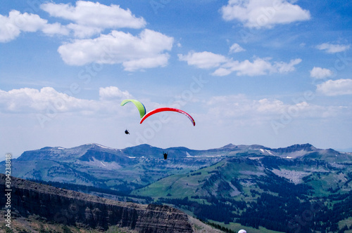 red and yellow paragliders