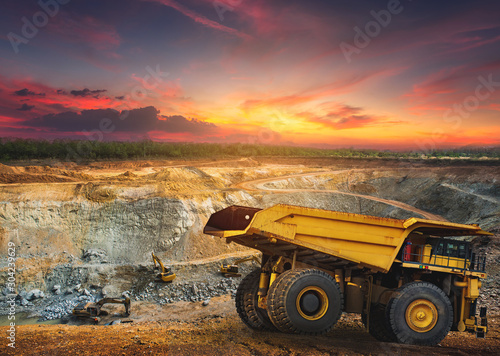Fotografie, Obraz Yellow dump truck loading minerals copper, silver, gold, and other  at mining quarry