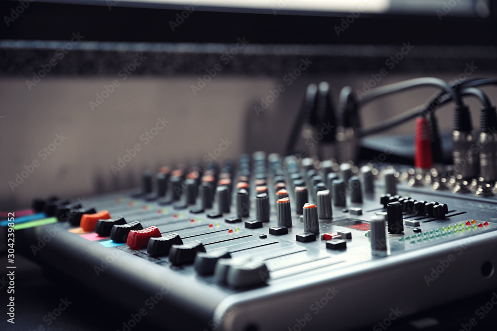Modern audio mixing console, closeup. Music equipment