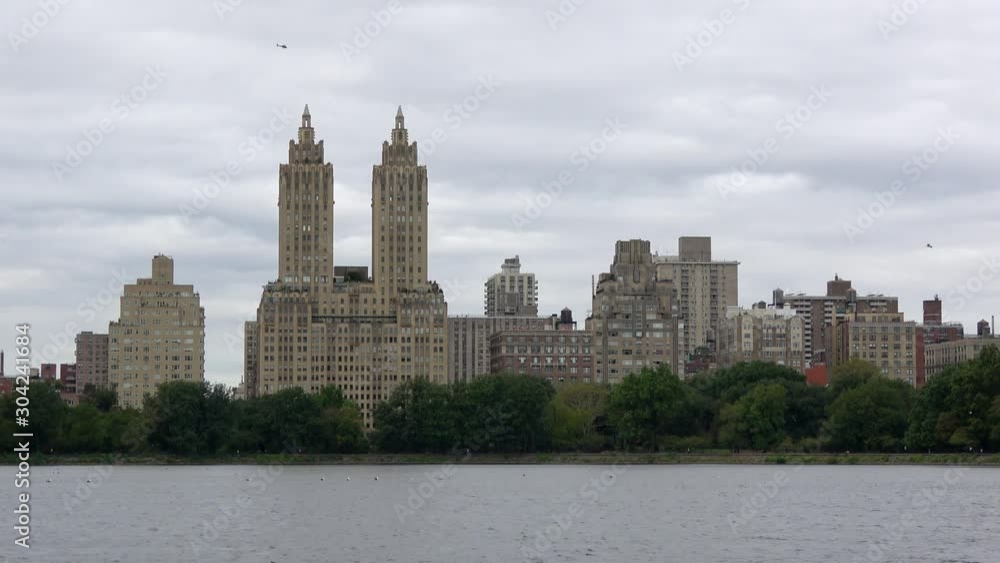 4K. Close-up view of the luxury San Remo residential building in Central Park, New York. Beautiful apartment building in Manhattan Upper West Side with lake views and green spaces in an urban setting. 4K. Close-up view of the luxury San Remo residential building in Central Park, New York. Beautiful apartment building in Manhattan Upper West Side with lake views and green spaces in an urban setting.