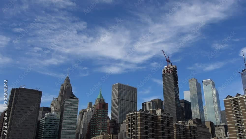 4K. Ultra HD. Skyline of the tall buildings of New York, seen upwards while the camera makes a panoramic view. New York buildings are very close to each other. Financial. 4K. Ultra HD. Skyline of the tall buildings of New York, seen upwards while the camera makes a panoramic view. New York buildings are very close to each other. Financial.