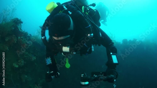 Wallpaper Mural Diver near shipwreck in underwater submarine world of ships from World War II as result of military battles on Truk Islands. Concept of diving in historic underwater sites of sunken wreck. Torontodigital.ca