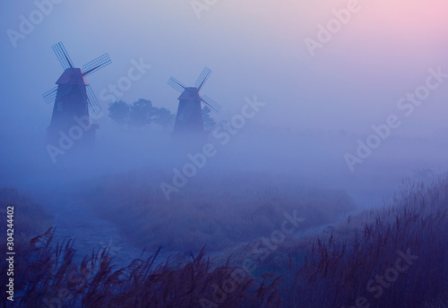 a foggy windmill scene