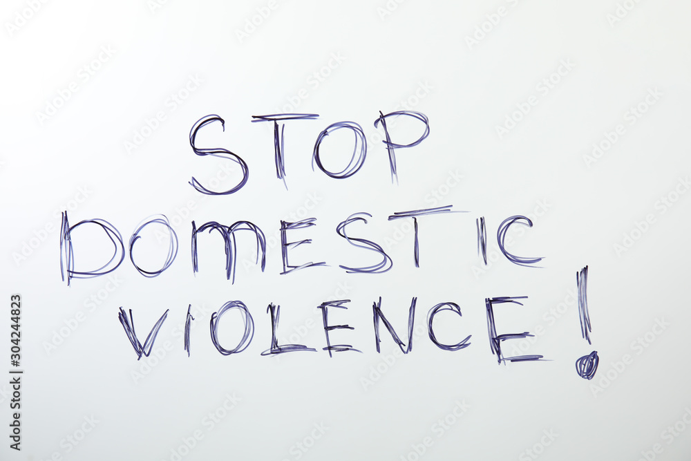 Phrase STOP DOMESTIC VIOLENCE on white background, top view Phrase STOP DOMESTIC VIOLENCE on white background, top view