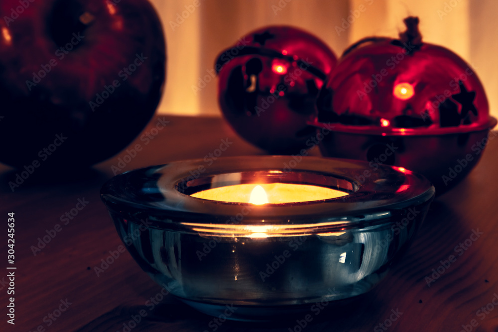 Christmas candles, red apples, cones and spices on rustic wooden background with Balls and Christmas lights. Close up, selective focus Christmas candles, red apples, cones and spices on rustic wooden background with Balls and Christmas lights. Close up, selective focus