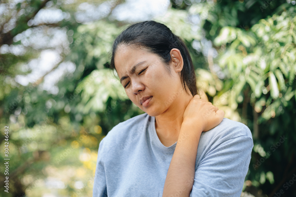 Young asian woman with pain in shoulder , Ache in human body , office syndrome , health care concept Young asian woman with pain in shoulder , Ache in human body , office syndrome , health care concept