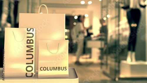 Wallpaper Mural Shopping bags with Columbus caption against blurred store entrance. Shopping in the United States related 3D animation Torontodigital.ca