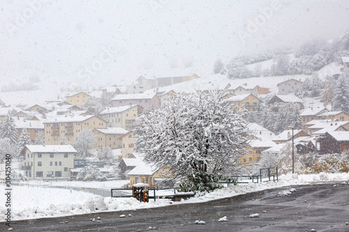 Heavy snowfall in alpine village Muestair. Canton of Graubuenden, Switzerland. photo
