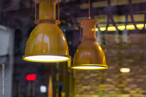 yellow lamps in the interior of the cafe. decorative illumination style © evgris