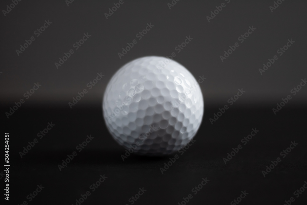 white golf ball on black background copy space white golf ball on black background copy space