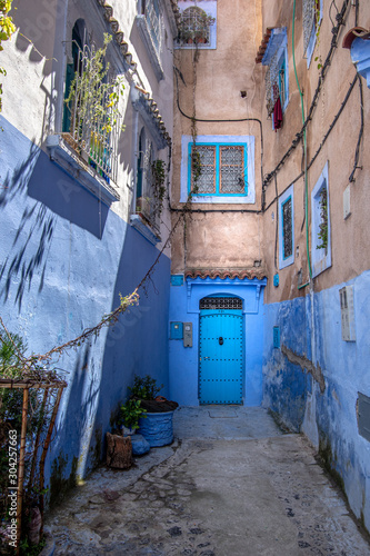 Panoramic view of the old traditional entrance to the house. Sunny day in blue city Chefchaouen, Morocco. © The Walker