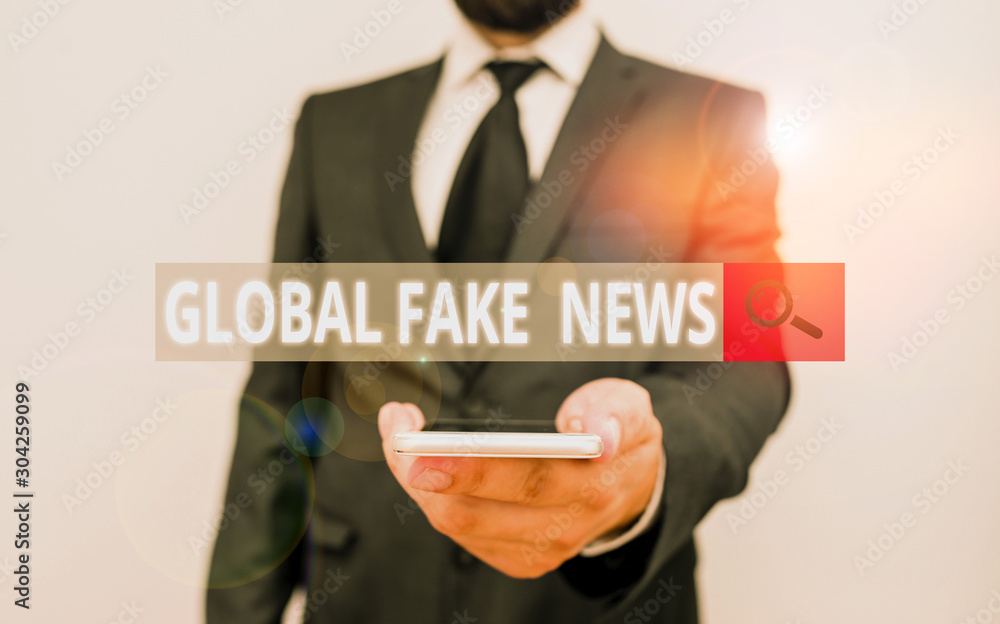 Word writing text Global Fake News. Business photo showcasing False information Journalism Lies Disinformation Hoax Male human wear formal work suit hold smart hi tech smartphone use one hand Word writing text Global Fake News. Business photo showcasing False information Journalism Lies Disinformation Hoax Male human wear formal work suit hold smart hi tech smartphone use one hand