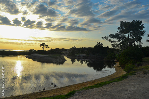 beautiful sunset with lights and clouds on a quiet beach in northern france landscape