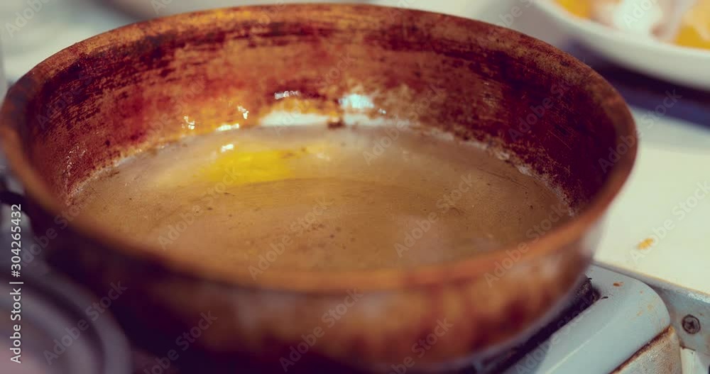 Vegetable oil is heated in a pan. Dough is thrown into hot oil. Cooking baking at home. Close-up. Vegetable oil is heated in a pan. Dough is thrown into hot oil. Cooking baking at home. Close-up.